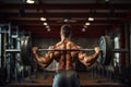 Handsome young muscular Caucasian man working out in a gym gaining weight pumping up muscles and poses fitness and bodybuilding