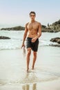 Handsome young muscular italian man posing shirtless on the beach, summer time Royalty Free Stock Photo