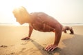 Handsome young muscular male model doing the workout stretching warm up on the beach summer.sexy athlete abs and perfect Royalty Free Stock Photo