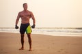 Handsome young muscular male model doing the workout stretching warm up on the beach summer.sexy athlete abs and perfect Royalty Free Stock Photo