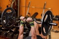 Handsome young muscular man close up, doing bench french press workout with barbell in gym. Royalty Free Stock Photo