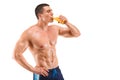 Handsome young muscular man drinking juice isolated on white background Royalty Free Stock Photo