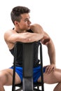Handsome young muscular man sitting on chair Royalty Free Stock Photo