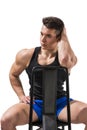 Handsome young muscular man sitting on chair Royalty Free Stock Photo