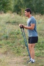 Handsome young muscular sports man exercising outside outdoor with rubber band. Royalty Free Stock Photo