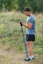 Handsome young muscular sports man exercising outside outdoor with rubber band. Royalty Free Stock Photo