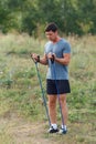 Handsome young muscular sports man exercising outside outdoor with rubber band. Royalty Free Stock Photo