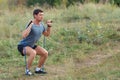 Handsome young muscular sports man exercising outside outdoor with rubber band. Royalty Free Stock Photo