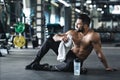 Handsome young muscular sportsman resting after workout