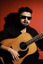 Handsome young musician playing the guitar and singing