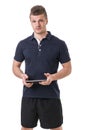 Handsome young personal trainer with tablet PC