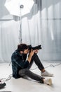 handsome young photographer with professional camera taking pictures Royalty Free Stock Photo