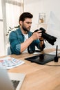 handsome young photographer using camera Royalty Free Stock Photo