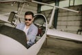 Young pilot checking ultralight airplane before flight Royalty Free Stock Photo