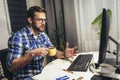 Young programmer working at home late in evening Royalty Free Stock Photo