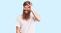 Handsome young red head man with long beard wearing casual white tshirt doing ok gesture with hand smiling, eye looking through Royalty Free Stock Photo