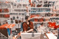 A handsome young seller of locksmith tools at his workplace at a table from a computer. Russian text: checkout