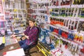 a handsome young seller of locksmith tools at his workplace at a table from a computer. Russian text: checkout