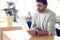 Handsome young smiling businessman working with documents.