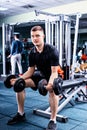Handsome young sportive man in sportswear lifting some weights Royalty Free Stock Photo