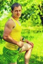 Handsome young sportsman lifting weights in green park instagram Royalty Free Stock Photo