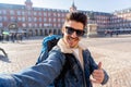 Handsome young student tourist man happy and excited taking a selfie in Madrid, Spain Royalty Free Stock Photo