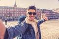 Handsome young student tourist man happy and excited taking a selfie in Madrid, Spain Royalty Free Stock Photo