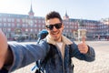 Handsome young student tourist man happy and excited taking a selfie in Madrid, Spain Royalty Free Stock Photo