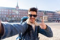 Handsome young student tourist man happy and excited taking a selfie in Madrid, Spain Royalty Free Stock Photo