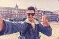 Handsome young student tourist man happy and excited taking a selfie in Madrid, Spain Royalty Free Stock Photo