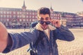 Handsome young student tourist man happy and excited taking a selfie in Madrid, Spain Royalty Free Stock Photo