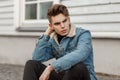 Handsome young stylish man with a haircut in denim vintage