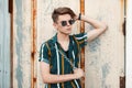 Handsome young stylish man with sunglasses in a fashion beach Royalty Free Stock Photo