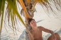 Handsome young tanned man relaxing at the beach at the tropical island luxury resort Royalty Free Stock Photo