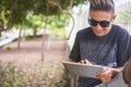 Handsome young teenager boy use laptop device oudoor with garden in background - technology and leisure activity for younger Royalty Free Stock Photo