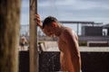 Handsome young topless caucasian man taking an outdoor shower on beach. Royalty Free Stock Photo