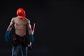 Handsome young topless construction worker with sledge hammer, studio shot, black background. builder Royalty Free Stock Photo