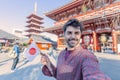 Handsome young tourist enjoying summer holiday in Tokyo, Japan - Traveling life style concept with smiling man taking selfie on Royalty Free Stock Photo