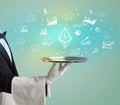 Handsome young waiter in tuxedo holding money icons on tray