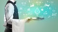 Handsome young waiter in tuxedo holding money icons on tray