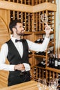 handsome young wine steward checking clean glass