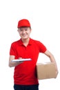 Handsome young worker in red t-shirt and cap smiling, holding a Royalty Free Stock Photo