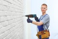 Handsome young working man using rotary hammer. Home repair Royalty Free Stock Photo