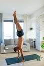 Handstand, home workout for young man. New Year& x27;s resolutions, exercising as healthy lifestyle and selfcare. Concept