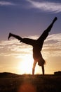 Handstand. Silhouette of a woman doing handstand at sunrise.