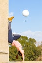 Handstand young woman girl yoga training hot air balloon.