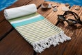 Handwoven blue hammam Turkish cotton towel on dark wooden bridge Royalty Free Stock Photo