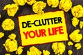 Handwriting Announcement text De-Clutter Your Life. Conceptual photo Free Less Chaos Fresh Clean Routine written on Yellow Stikcy Royalty Free Stock Photo