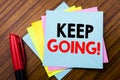 Handwriting Announcement text Keep Going. Concept for Go Moving Forward Letting Written on sticky stick note paper with wooden ba