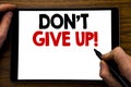 Handwriting Announcement text showing Don t Give Up. Business concept for Motivation Determination, Written on tablet laptop, wood